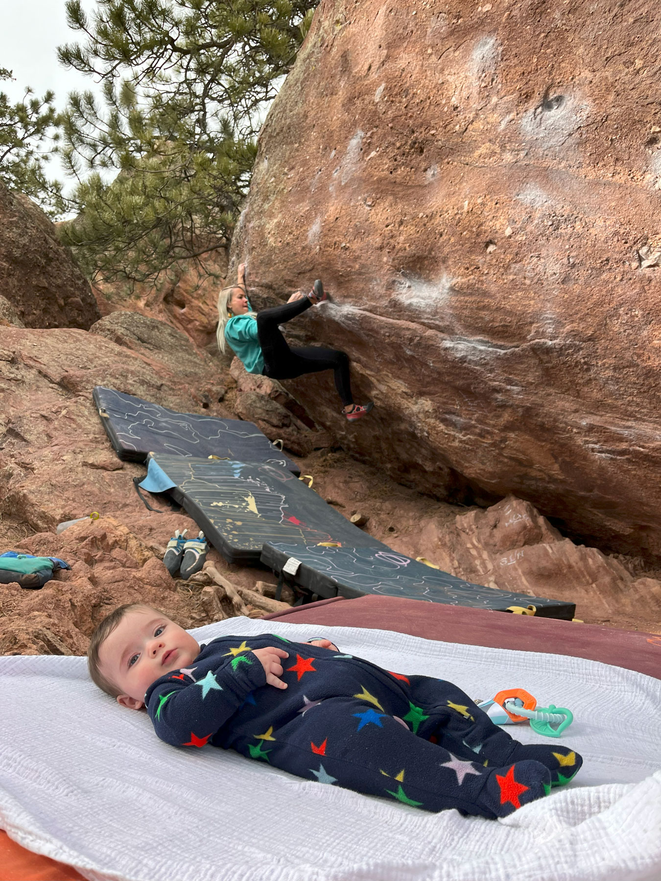 Fullerton bouldering outside, with her child on a mat