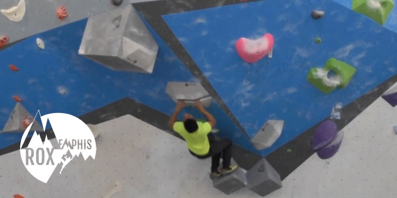 climber on a bouldering wall