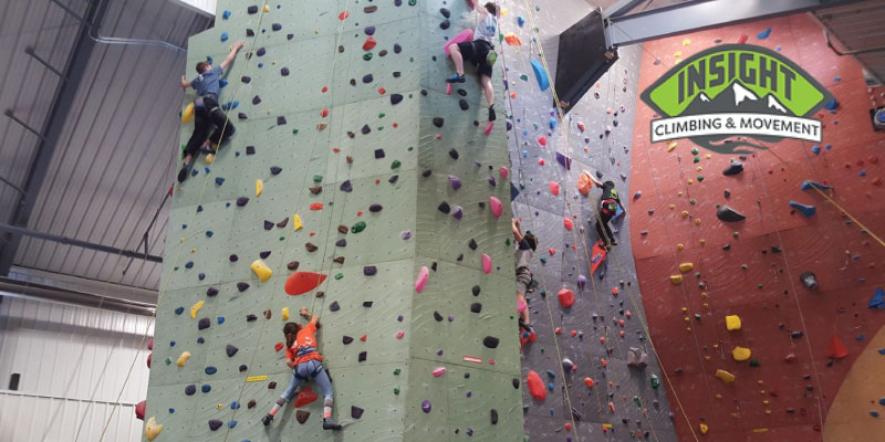 people climbing in a climbing gym