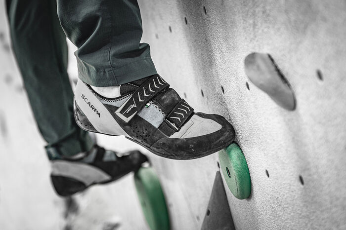 image of climber stepping on greenholds