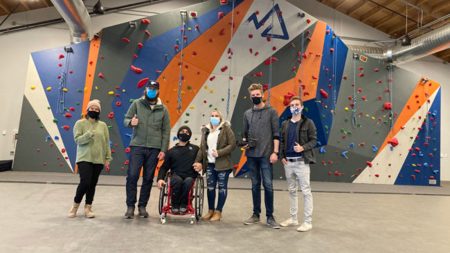 NAC climbers and staff in front of the climbing wall