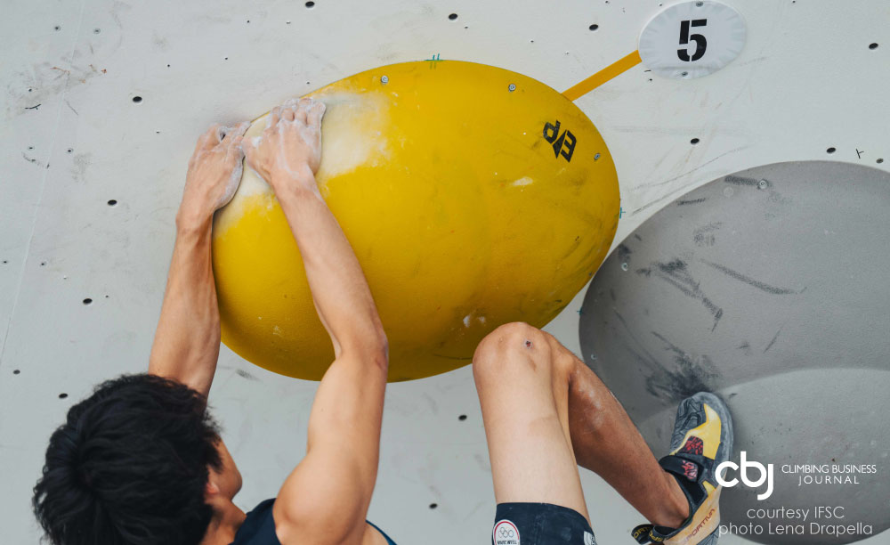 image of climber in competition on yellow hold